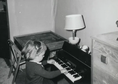 Sue at the piano as a child
